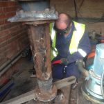 Engineer removing pipework and suction pipework from wet well.